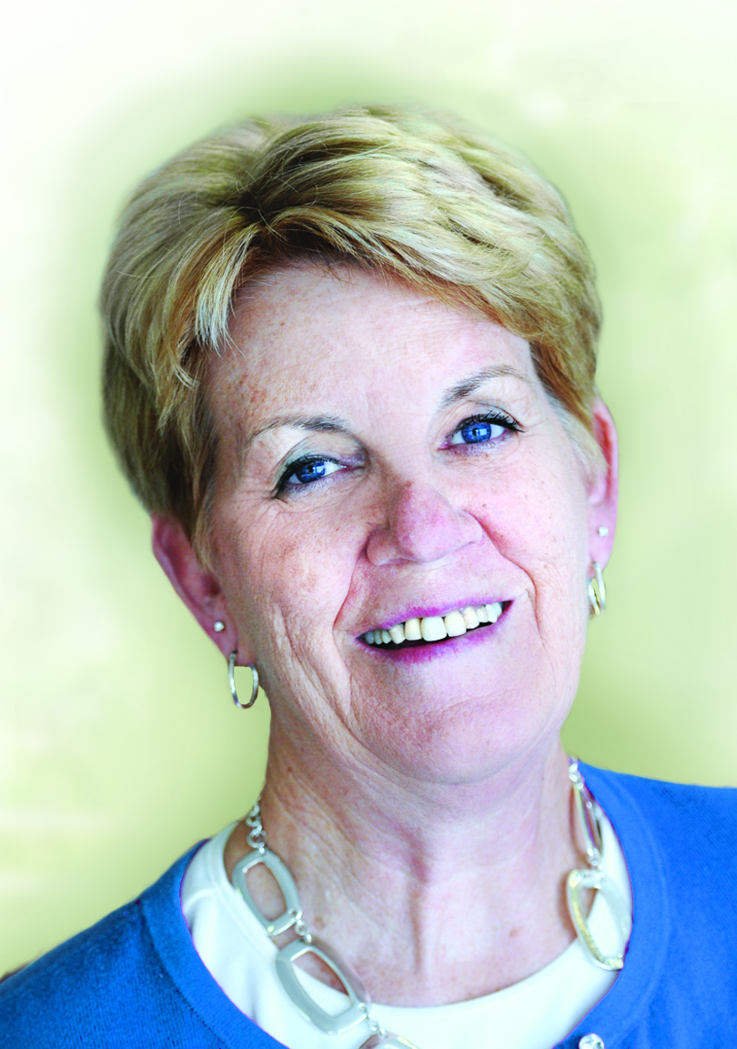 Smiling older woman with short blonde hair