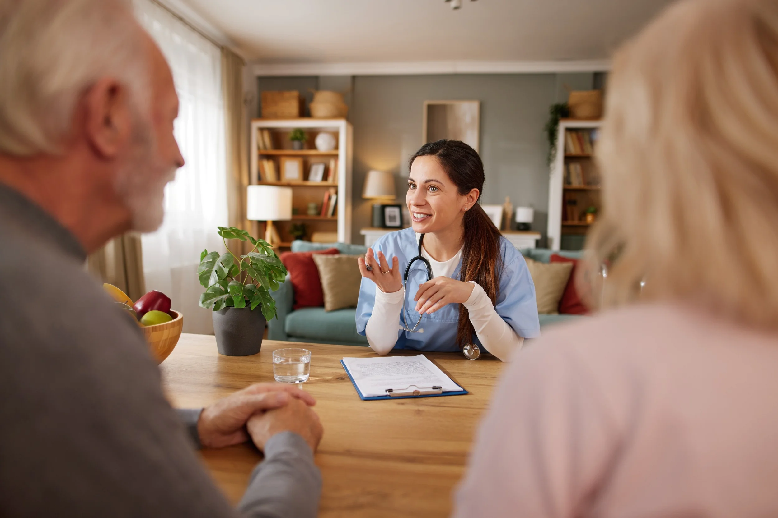 Doctor consulting with senior couple at home