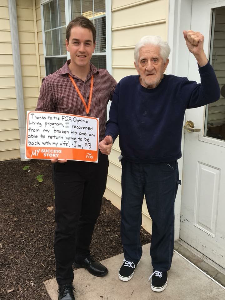 Two men celebrating recovery outside a house