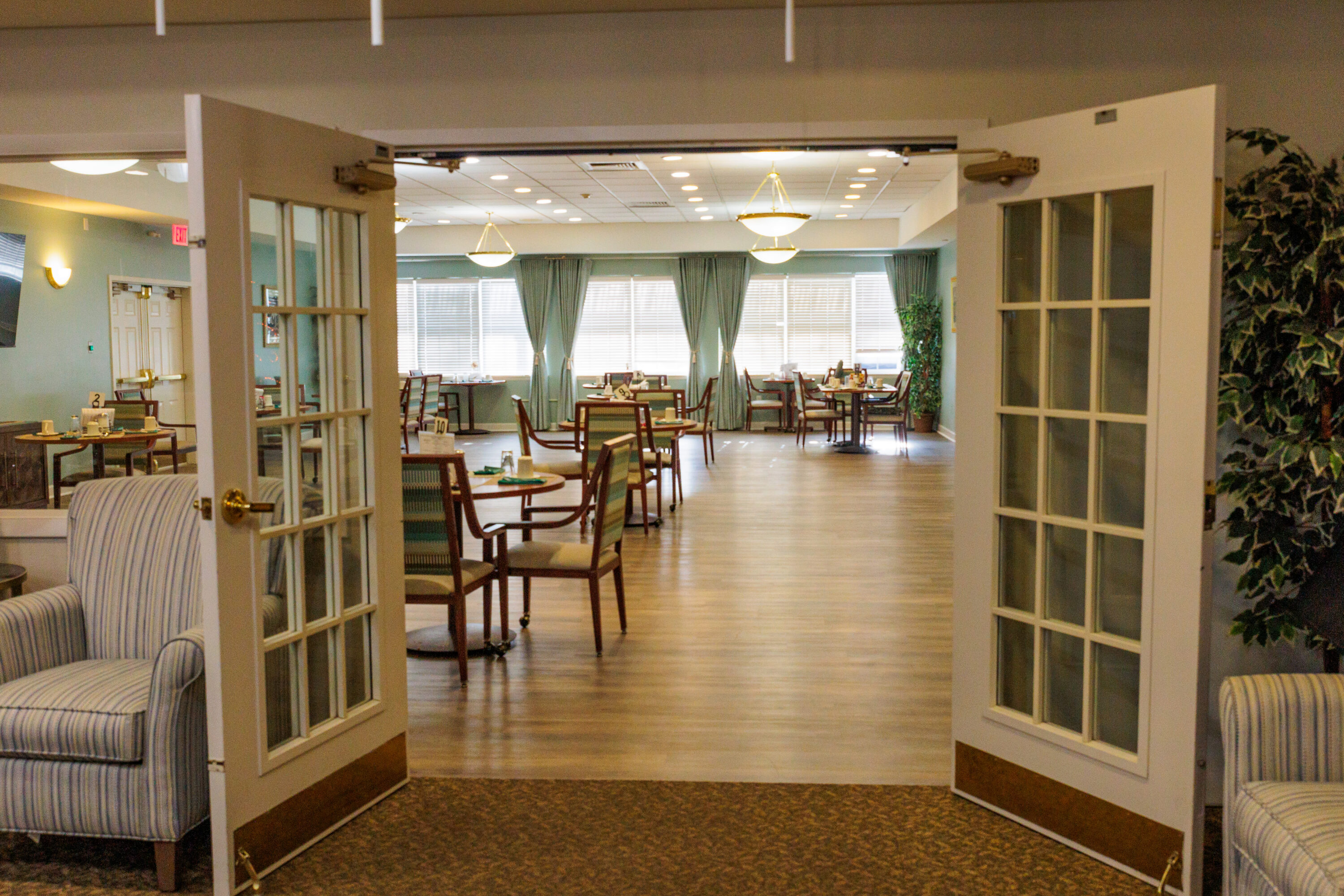 Open double doors leading to bright dining room