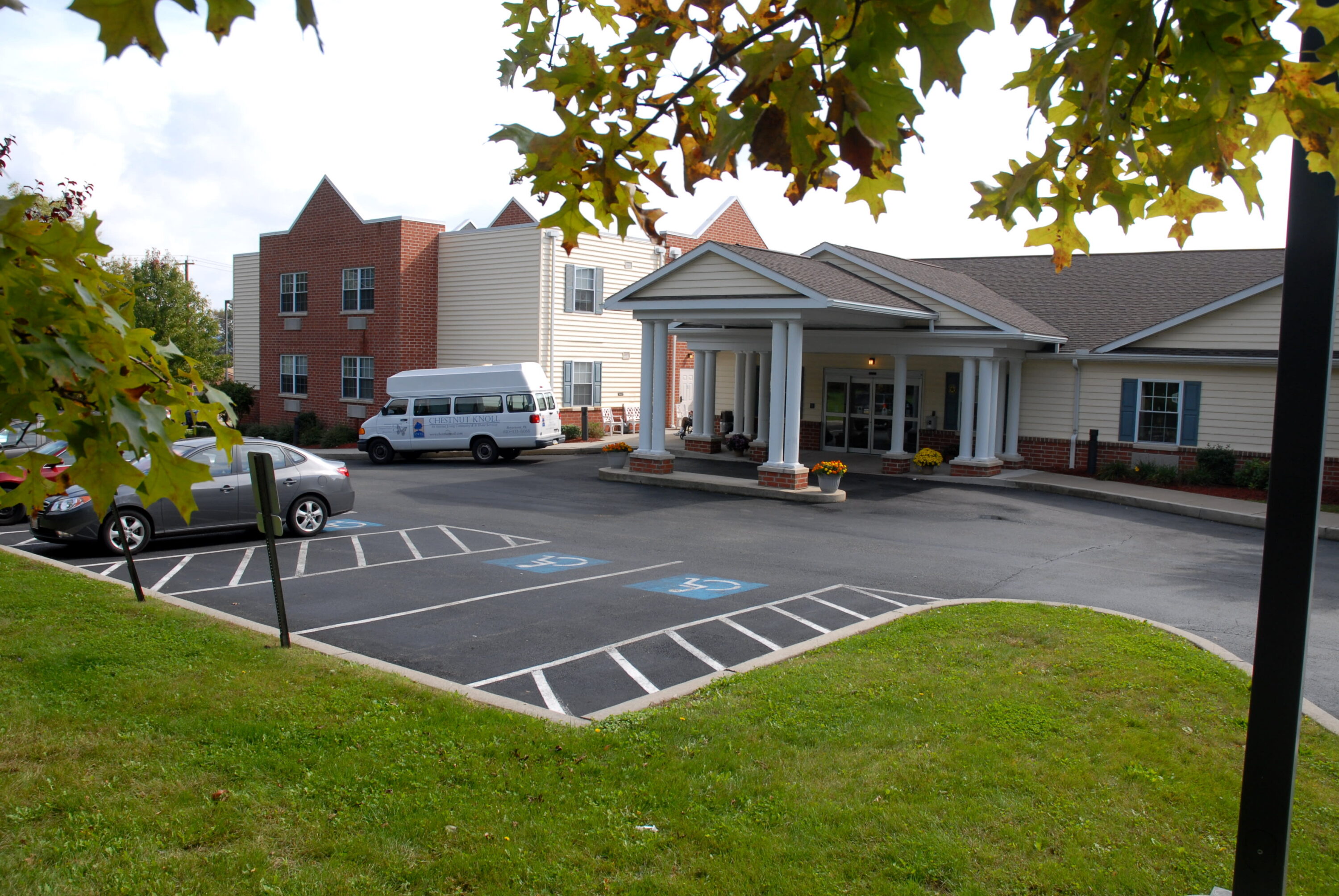 Senior living facility with covered entrance and van